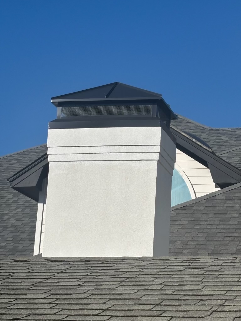 Custom chimney cap on a stucco chimney