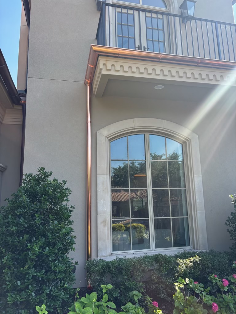 Copper seamless gutter and downspout on a custom home
